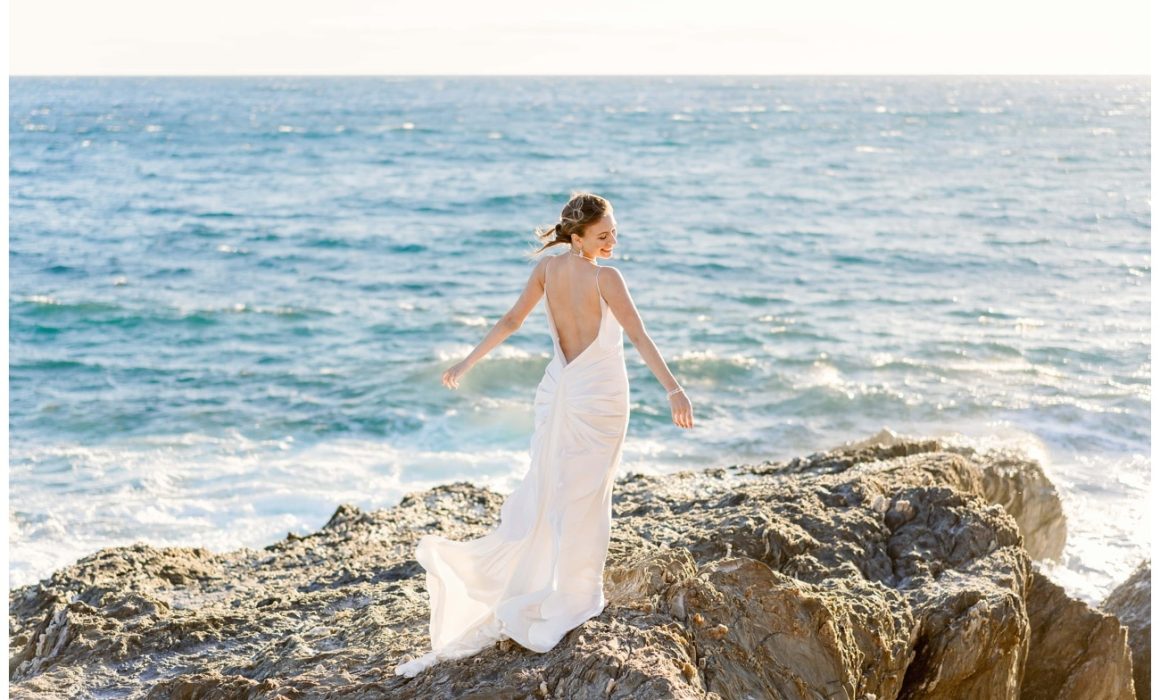 Bride on rocks in front of the sea