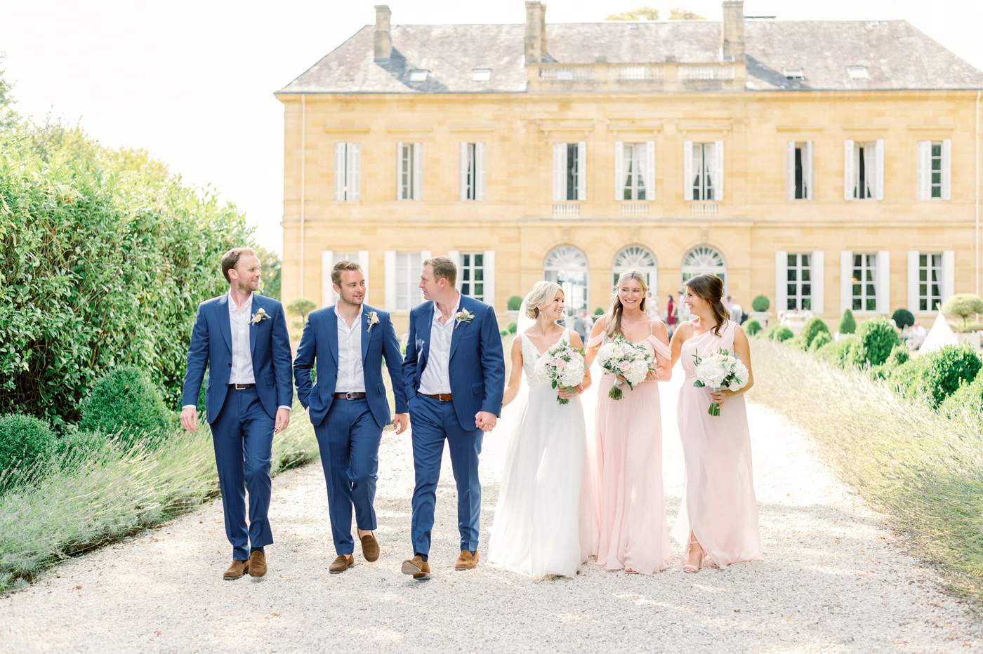 wedding party walking in the back of the chateau