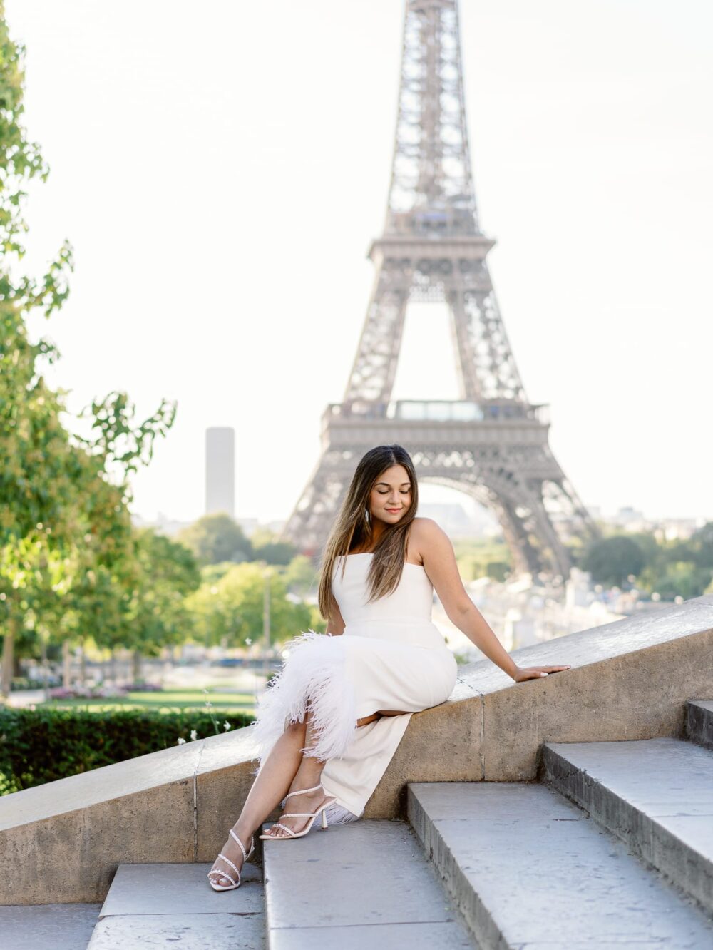 woman posing in front of the eiffel tower