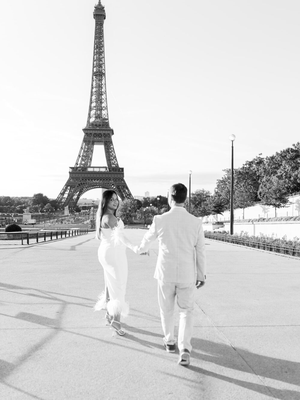 couple running towards Eiffel tower