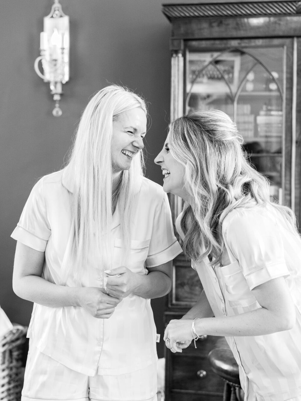 The bride and a bridesmaid laughing