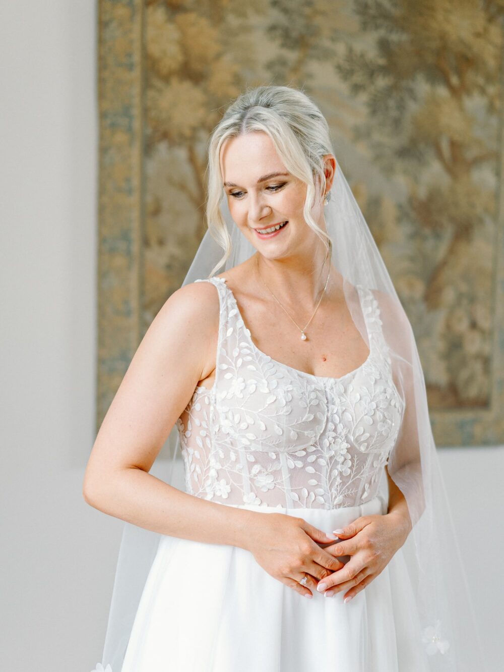 Portrait of the Bride in front of a tapestry