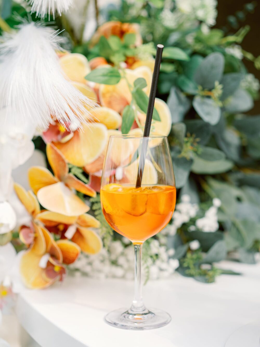Wedding cocktail spritz in front of colorful flowers