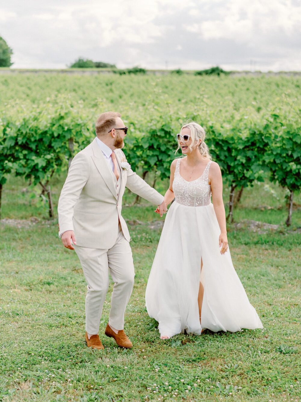 Bride and groom in front of the vine playing and wearing sunglasses