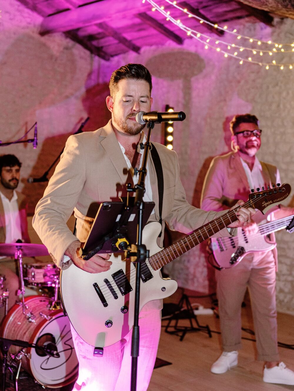 The music group playing guitar