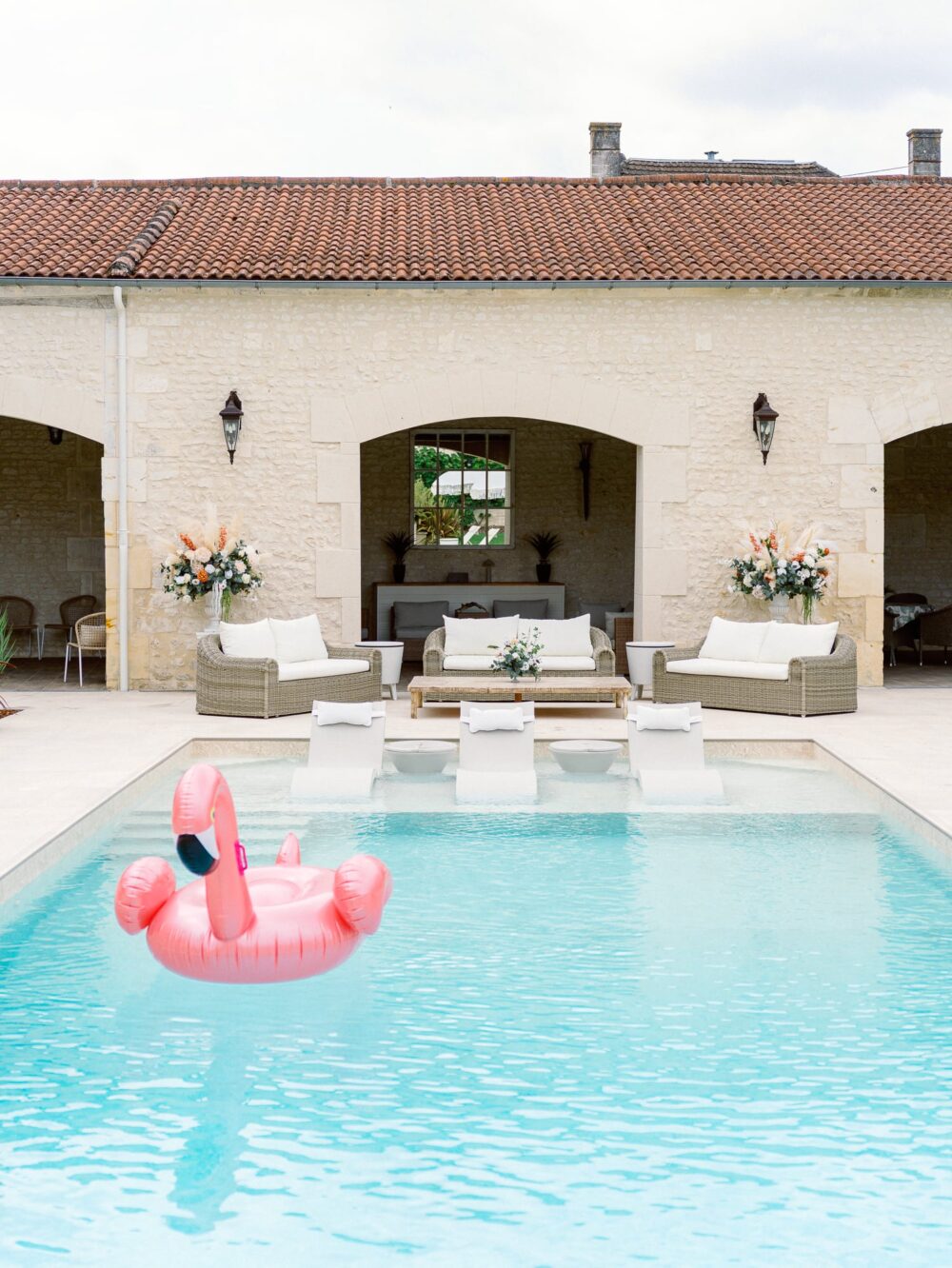 pink flamingo floating on the swimming pool