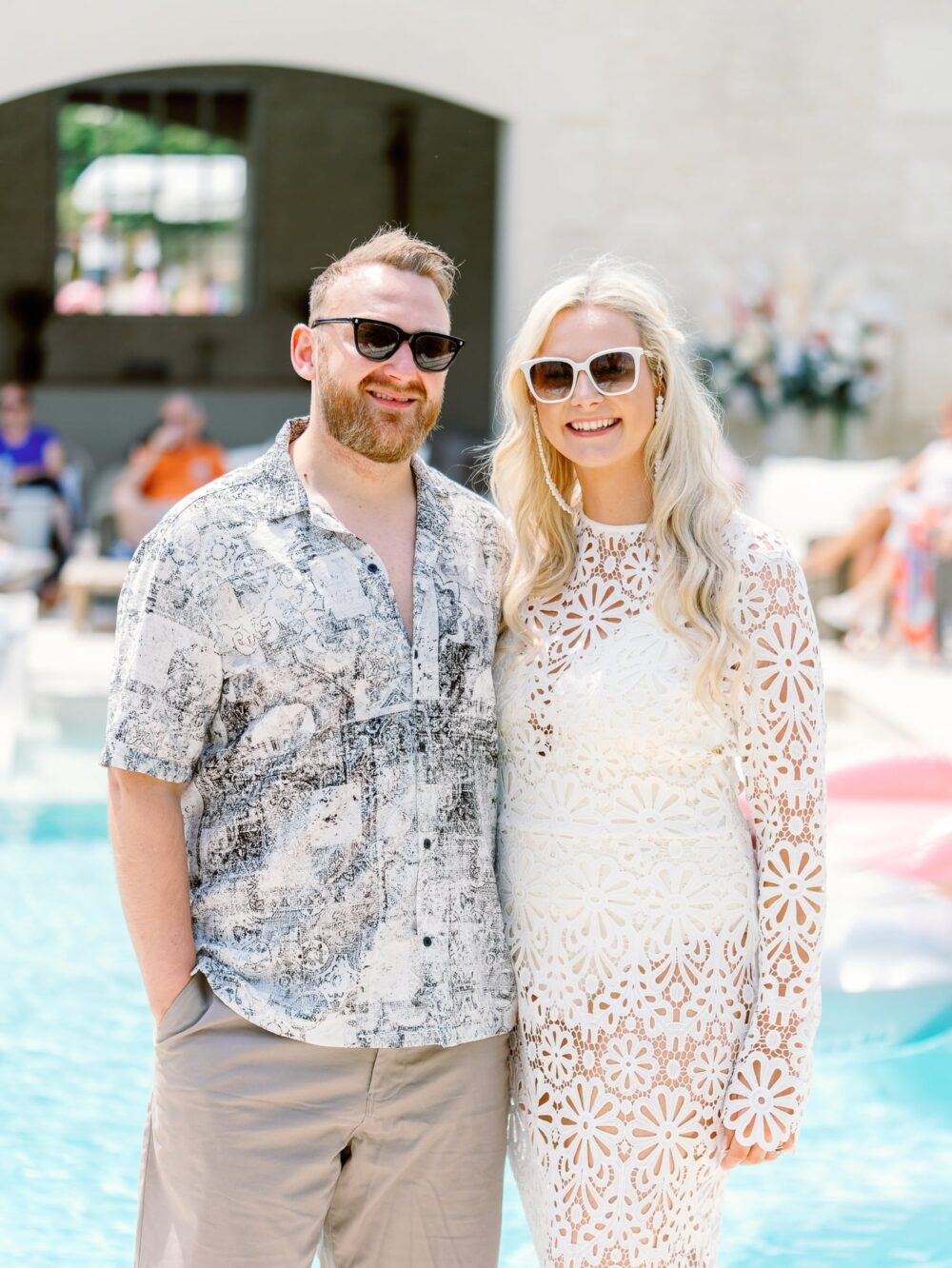 Bride and groom in front of the pool