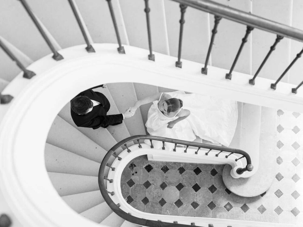 Bride and groom in the staircase of Chateau de Thauvenay