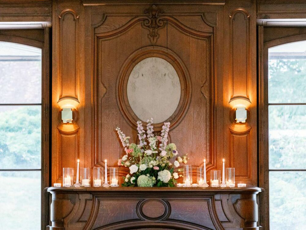 fireplace decorated with flowers and candles
