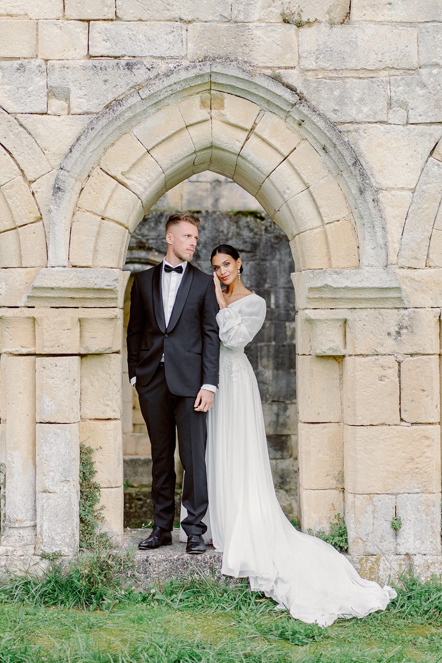 couple in front of an old abbey in France