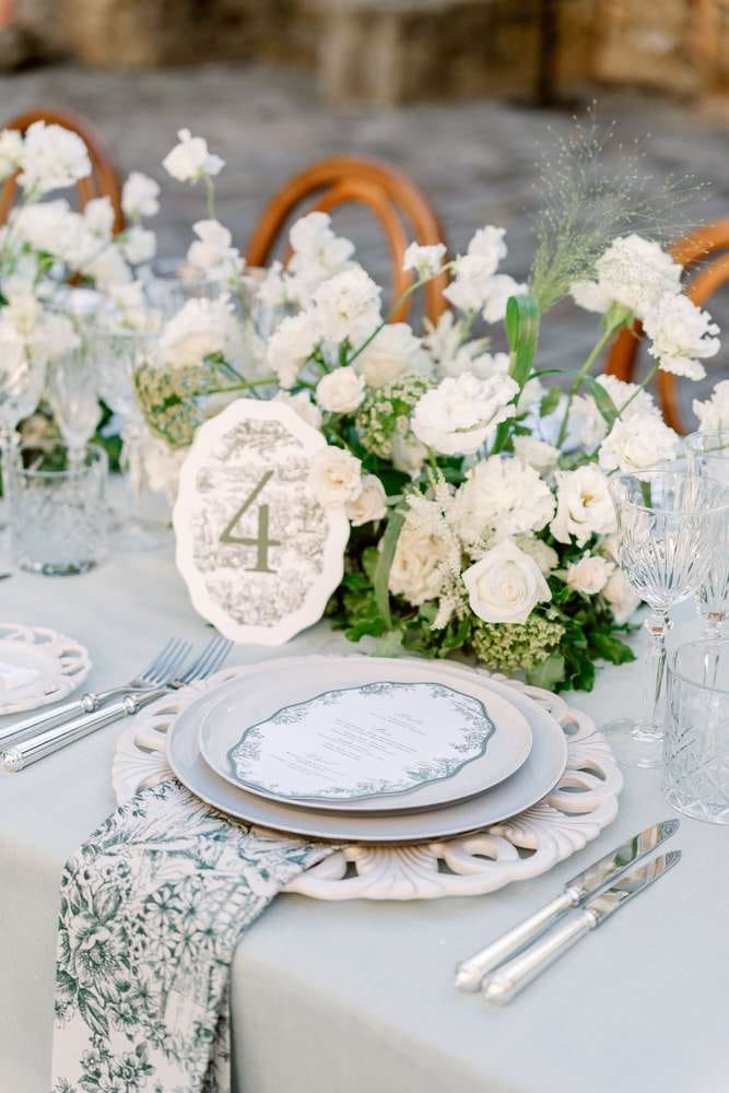 wedding table with a plate and grey tablecloth