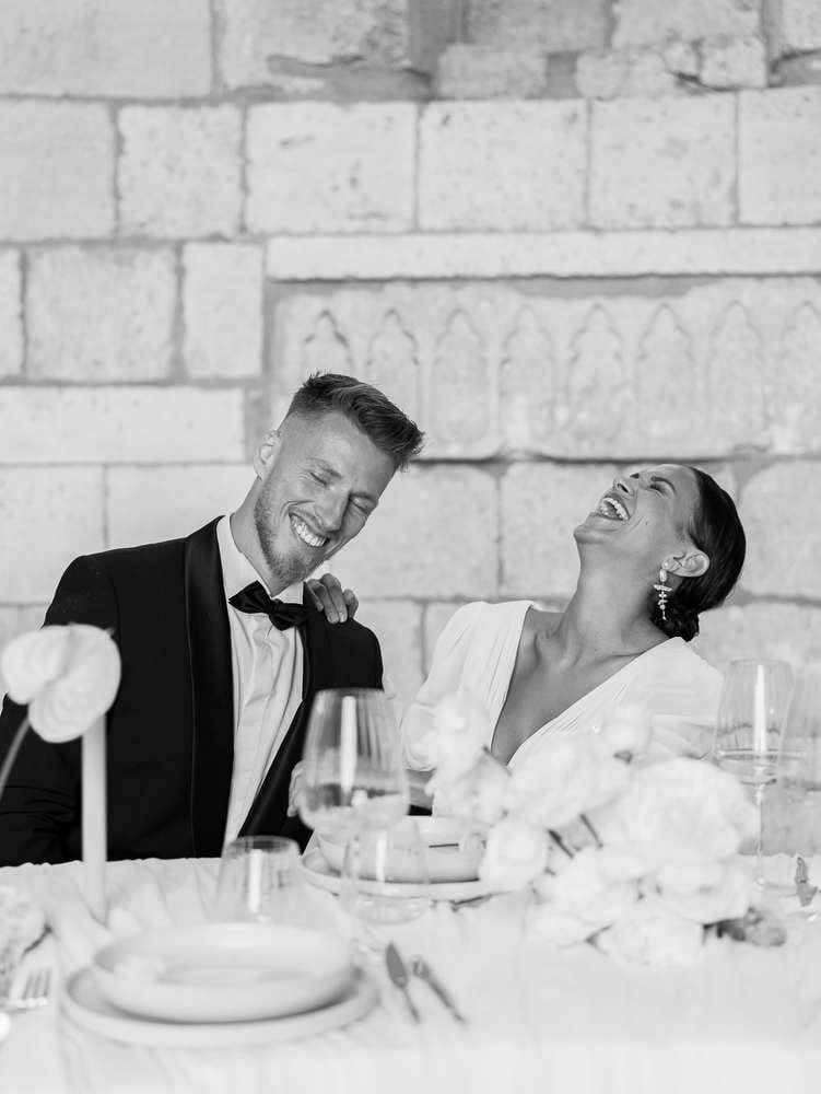 couple laughing during their wedding dinner