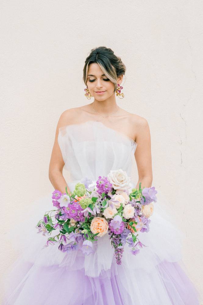 Bride in a purple dress holding a purple bouquet
