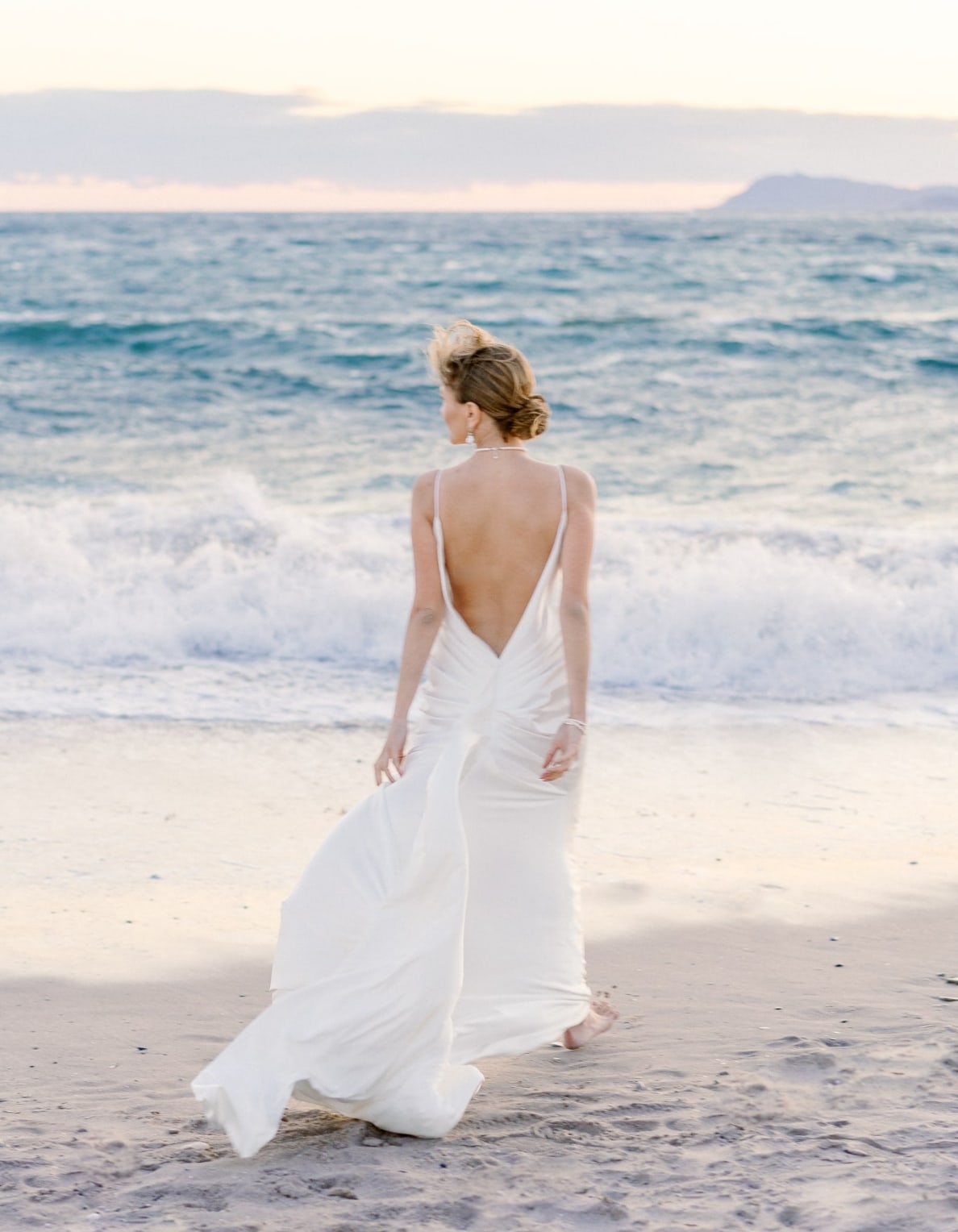Bride walking on the beach