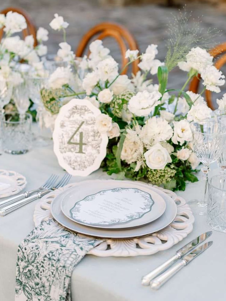 wedding table with toile de jouy, blue/grey tones, white flowers and green foliage