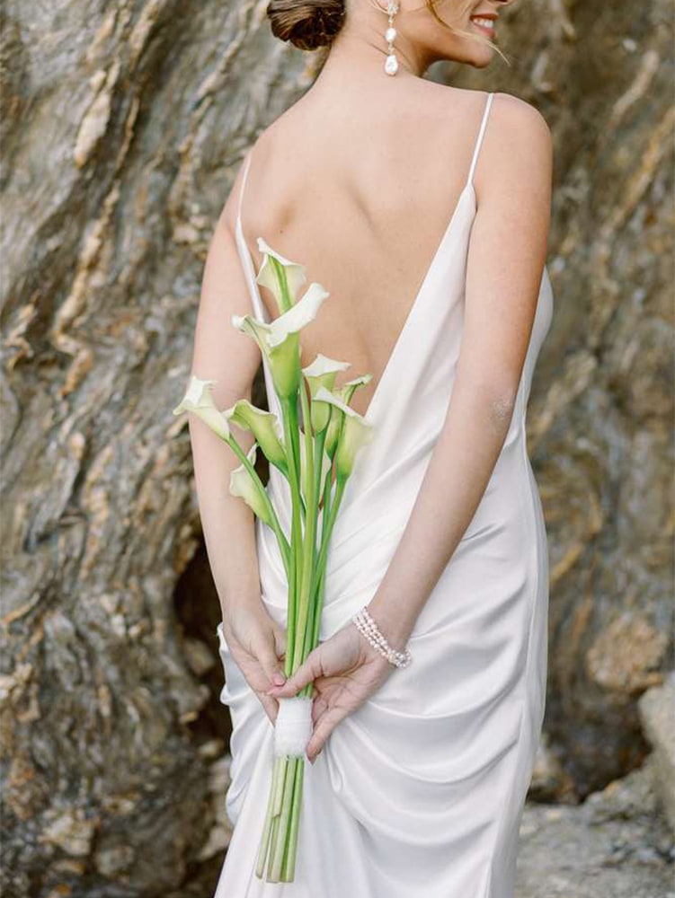 Bride holding a modern bouquet made with arums