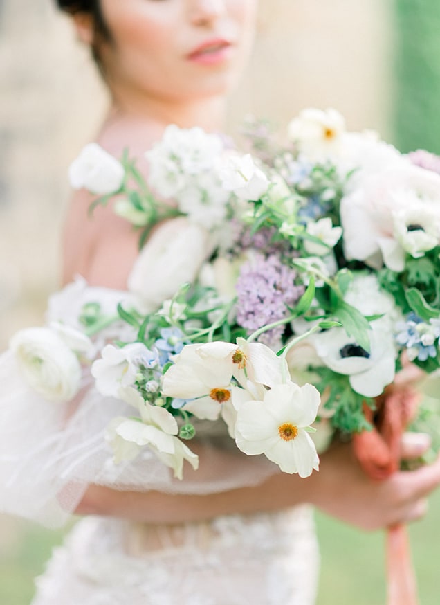 bridal bouquet with white and purple flowers and green foliage