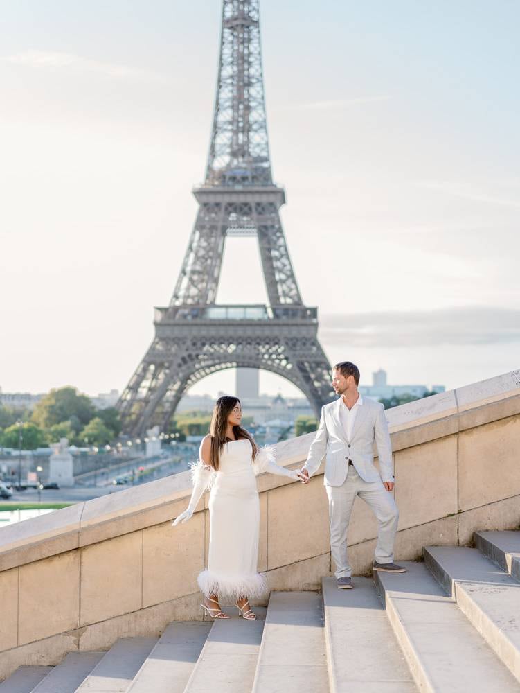 bride and groom in front of the eiffel tower