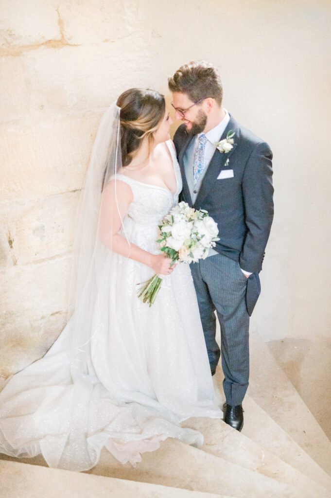 bride and groom in a chateau staircase