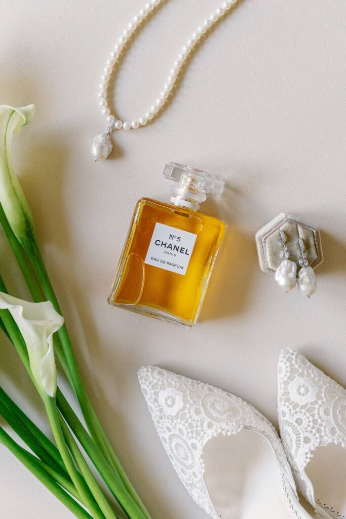 wedding flatlay with white shoes, chanel n°5 perfume