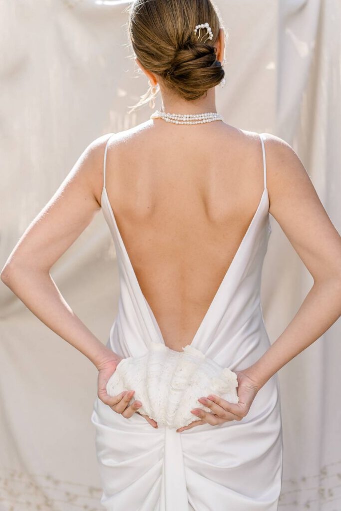 bride with a modern dress a a seashell