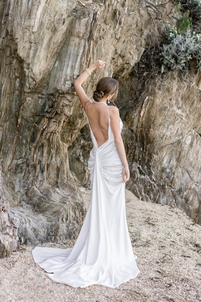 elegant bride in the rocks with an open back dress