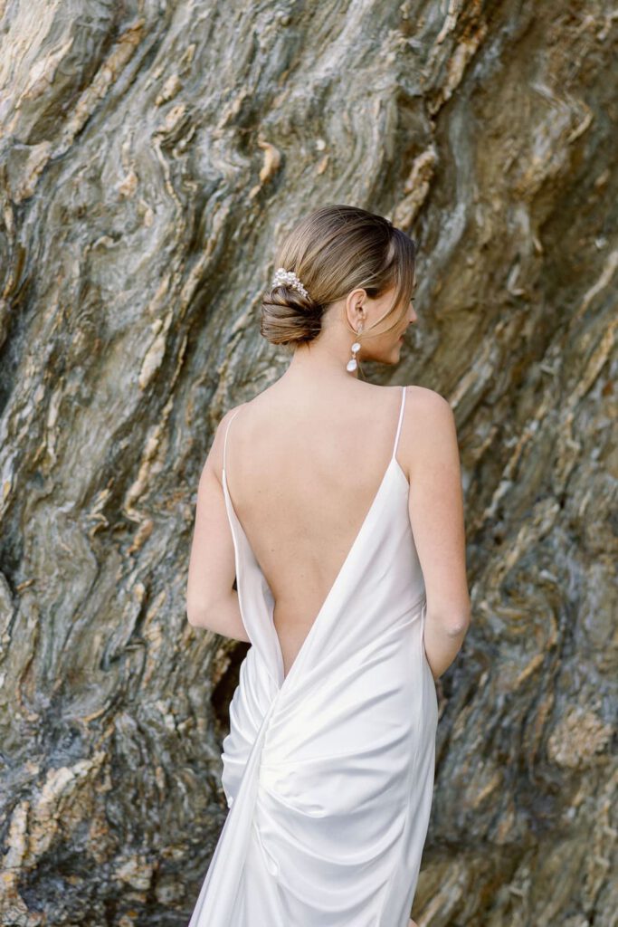 elegant bride in the rocks with an open back dress