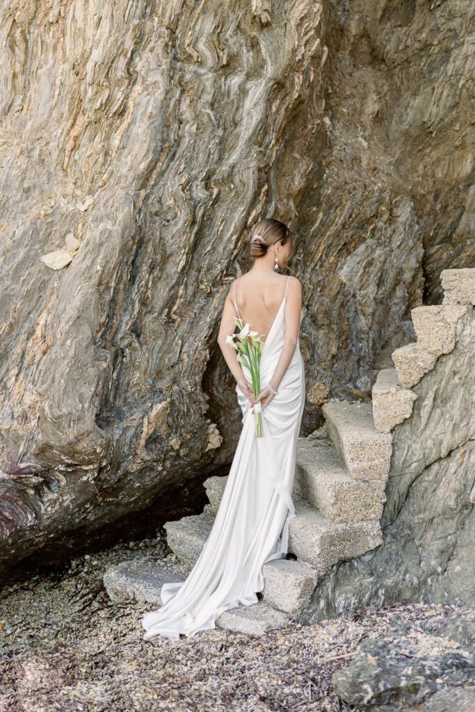 bride with a bouquet of arums in the back