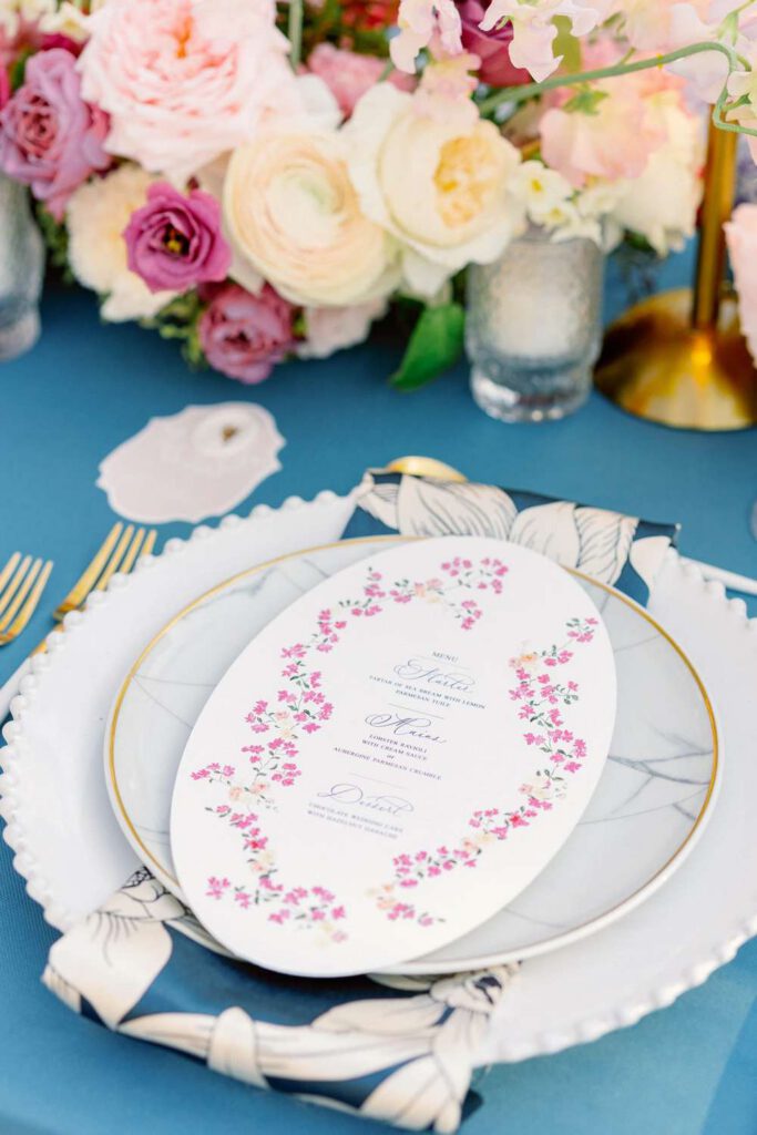 Blue wedding table with fushia flowers at castel bay