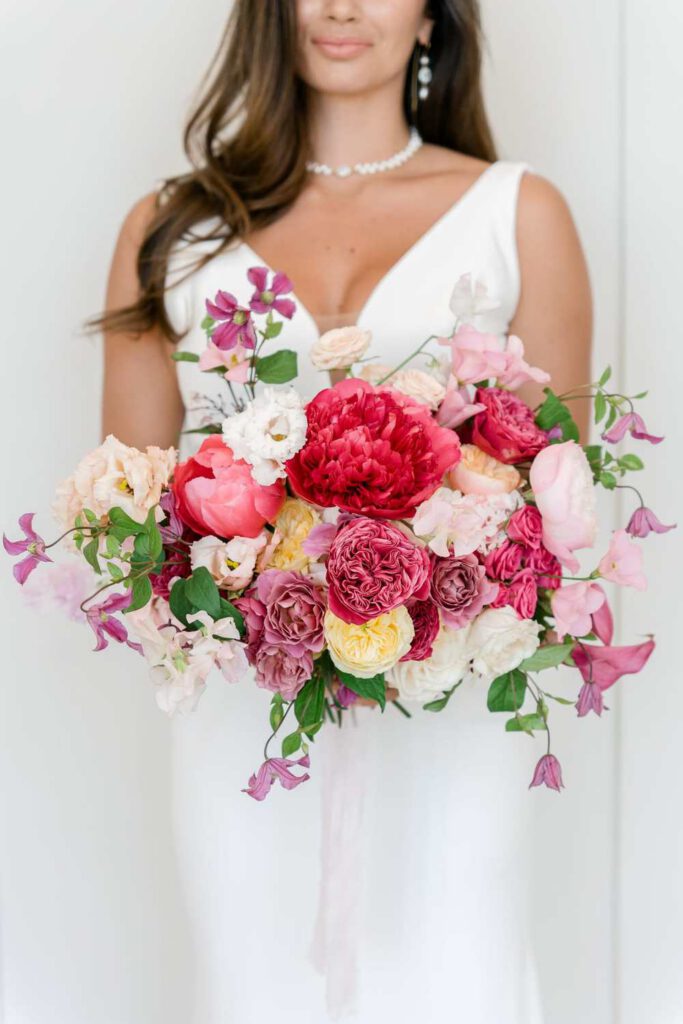 Bride with a bouquet in magenta and pink
