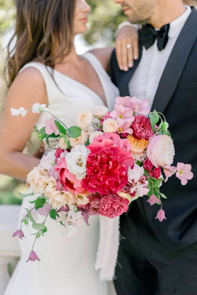 Bride and groom portrait with a pink bouquet