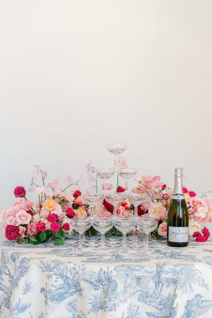 Champagne towers with fushia flowers