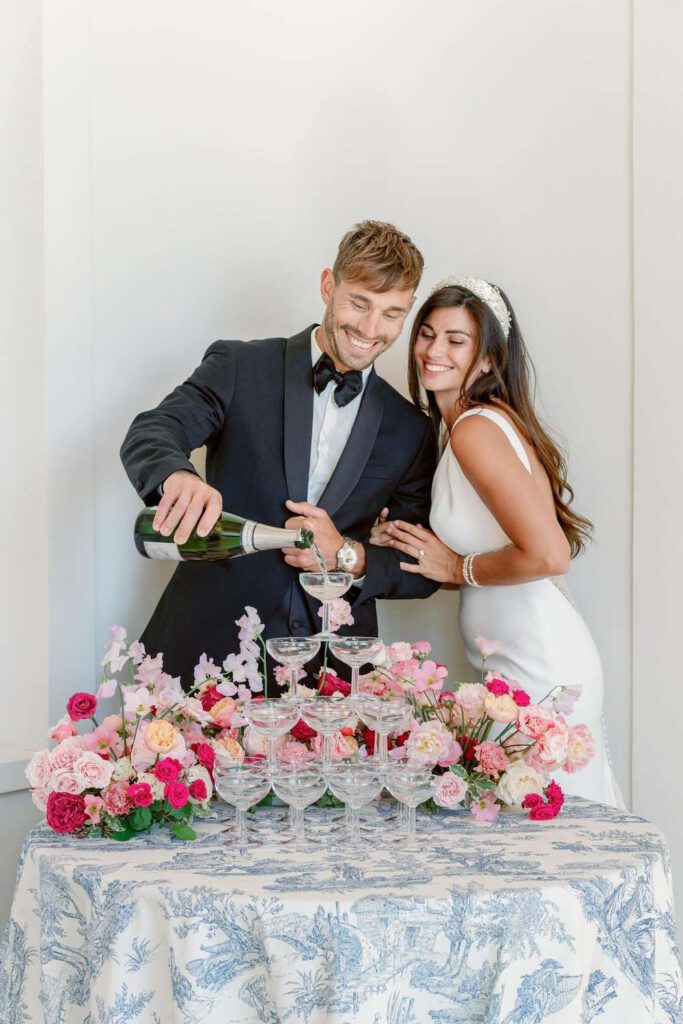 Bride and groom champagne towers with pink flowers