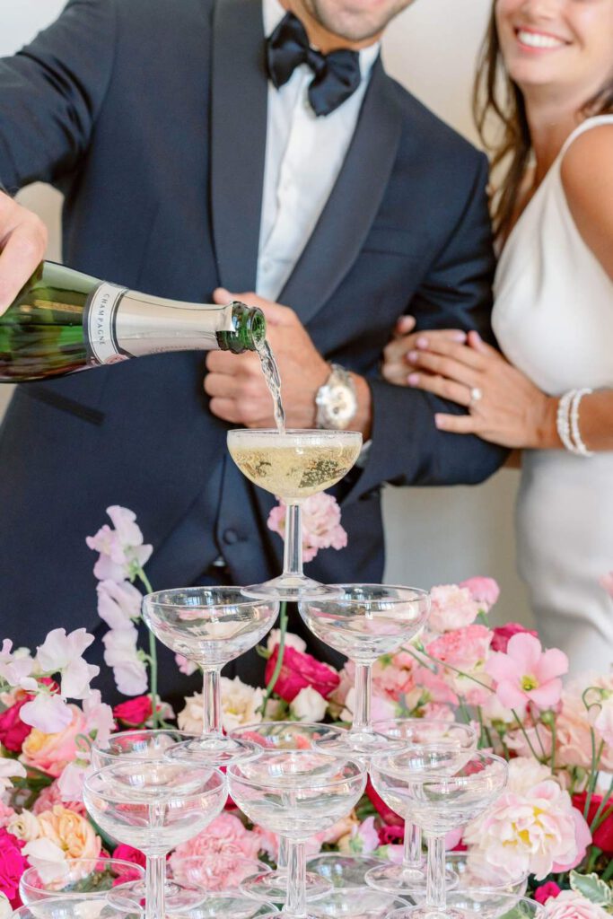 Bride and groom champagne towers with pink flowers