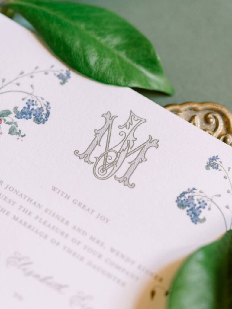 bride and groom monogram on wedding invitation