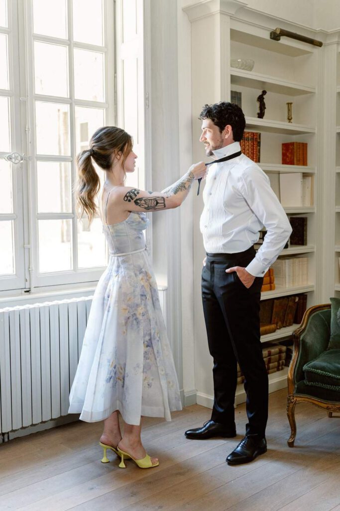 Groom getting dressed with his sister