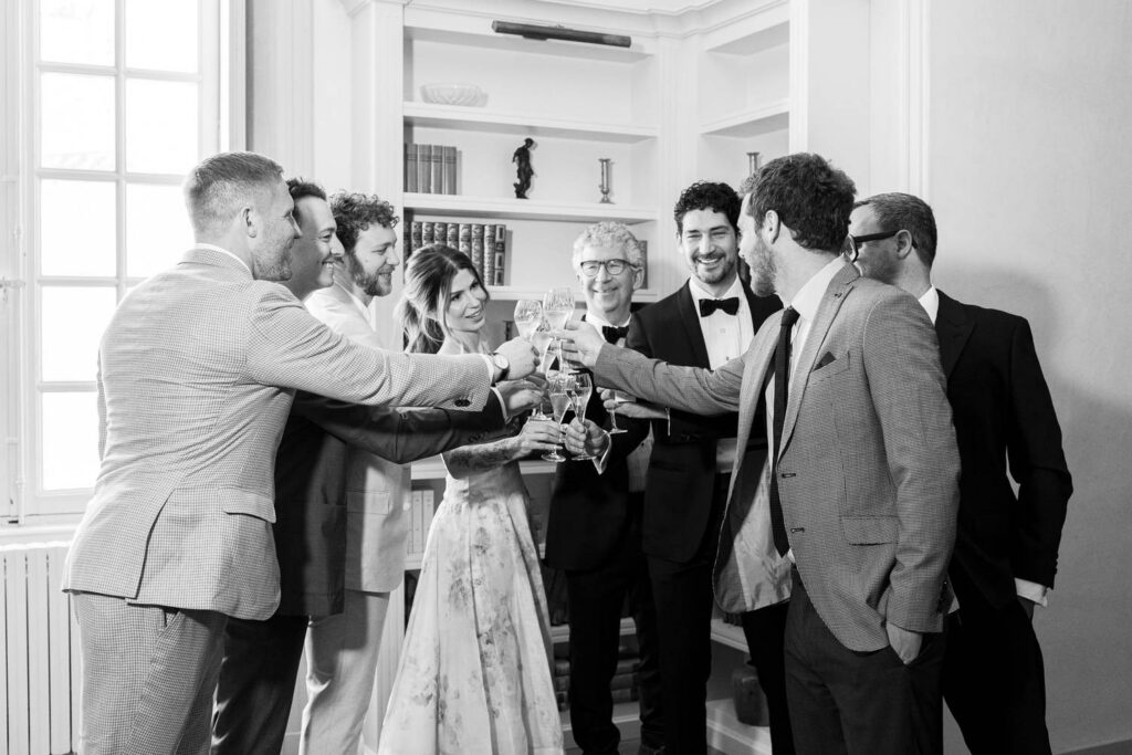groom and his family with glasses of champagne