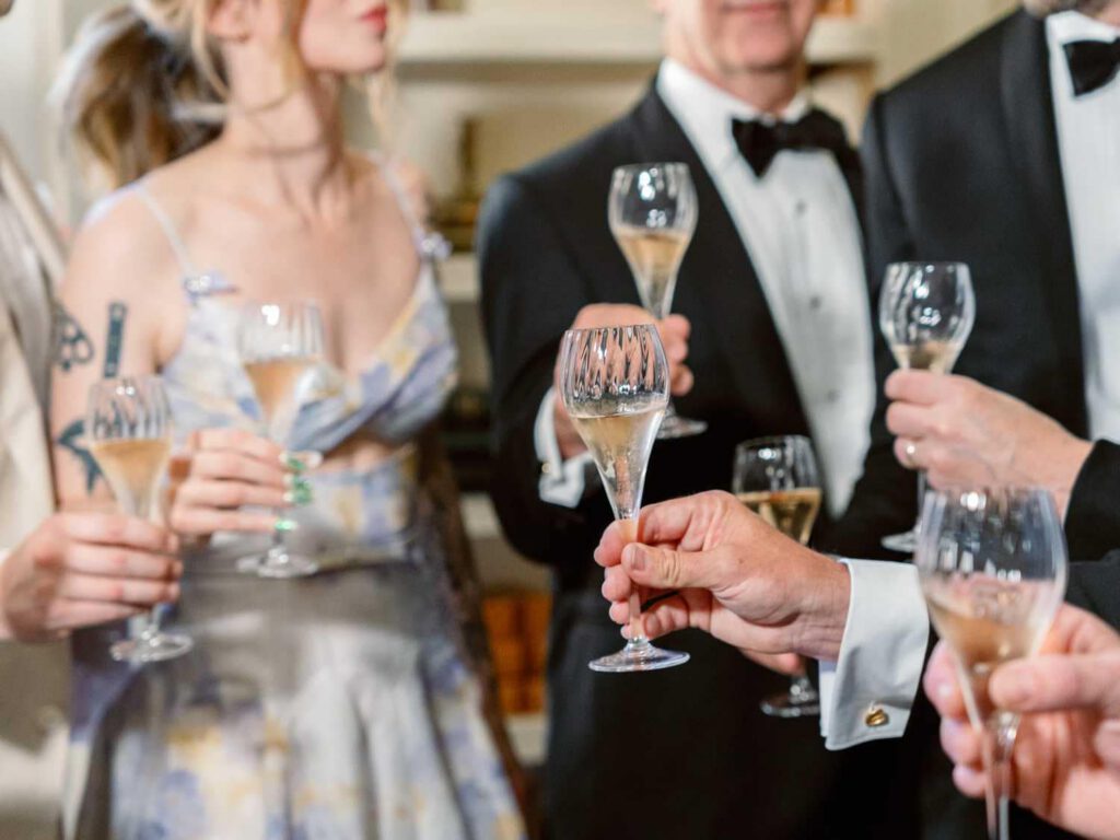 groom and his family with glasses of champagne