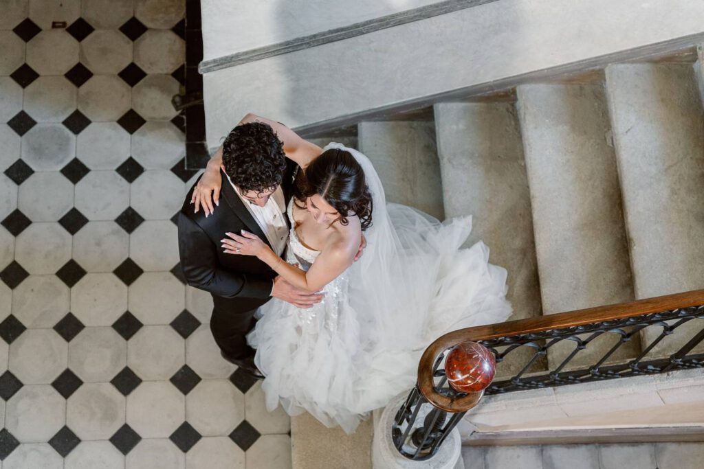 Bride and groom portrait in the staircase of Château de Fontarèches