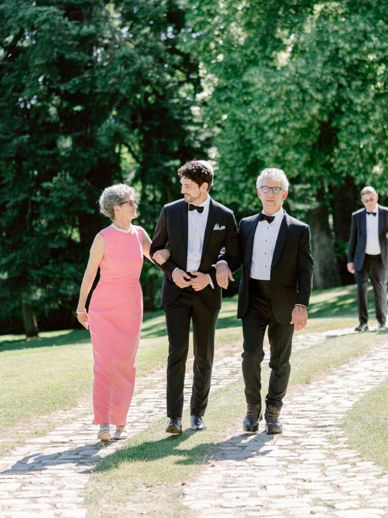 Groom walking with his parents