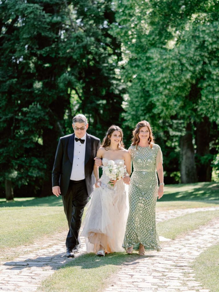 Bride walking with her parents