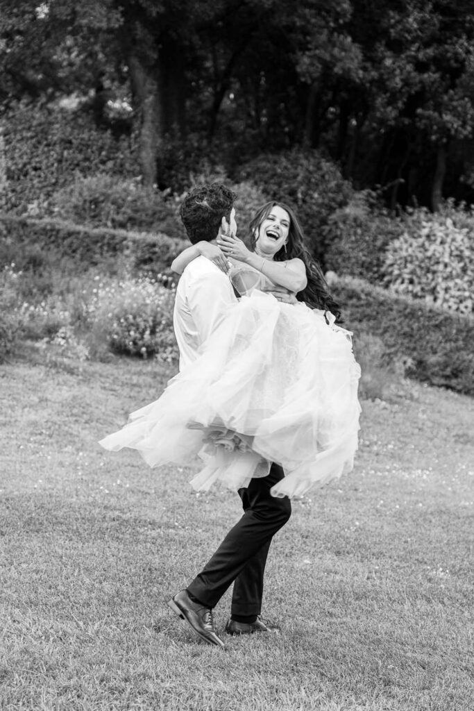 groom carrying the bride