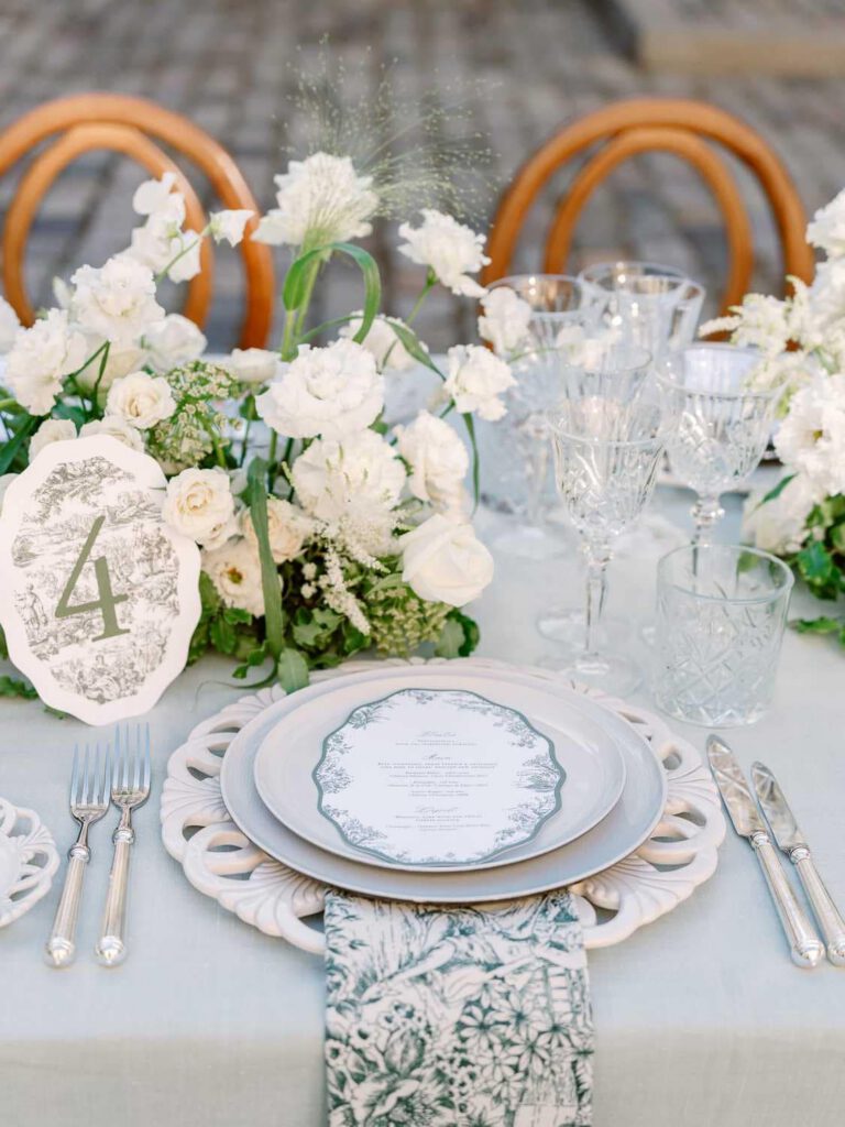 dinner place with grey tablecloth, white flowers and foliage at Château de Fontarèches