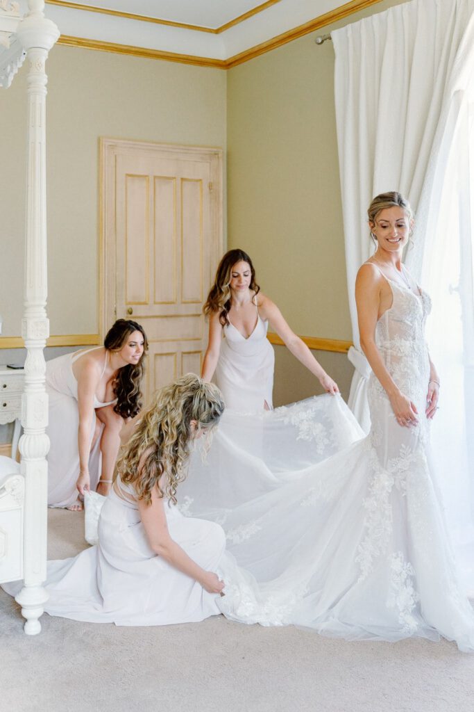 Bride getting dressed with her bridesmaids