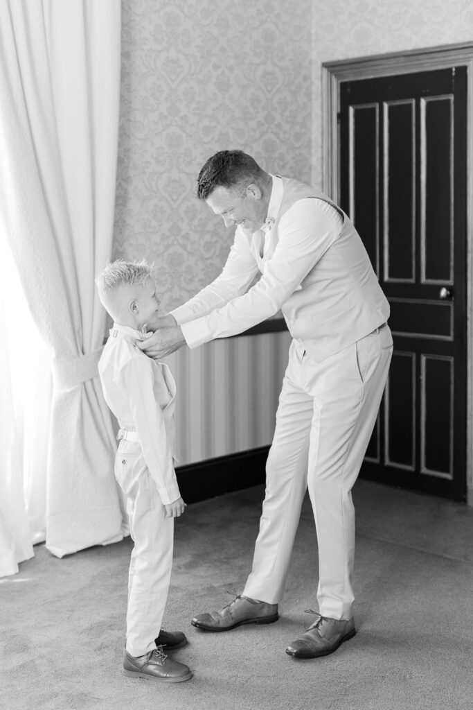 groom getting dressed with his son