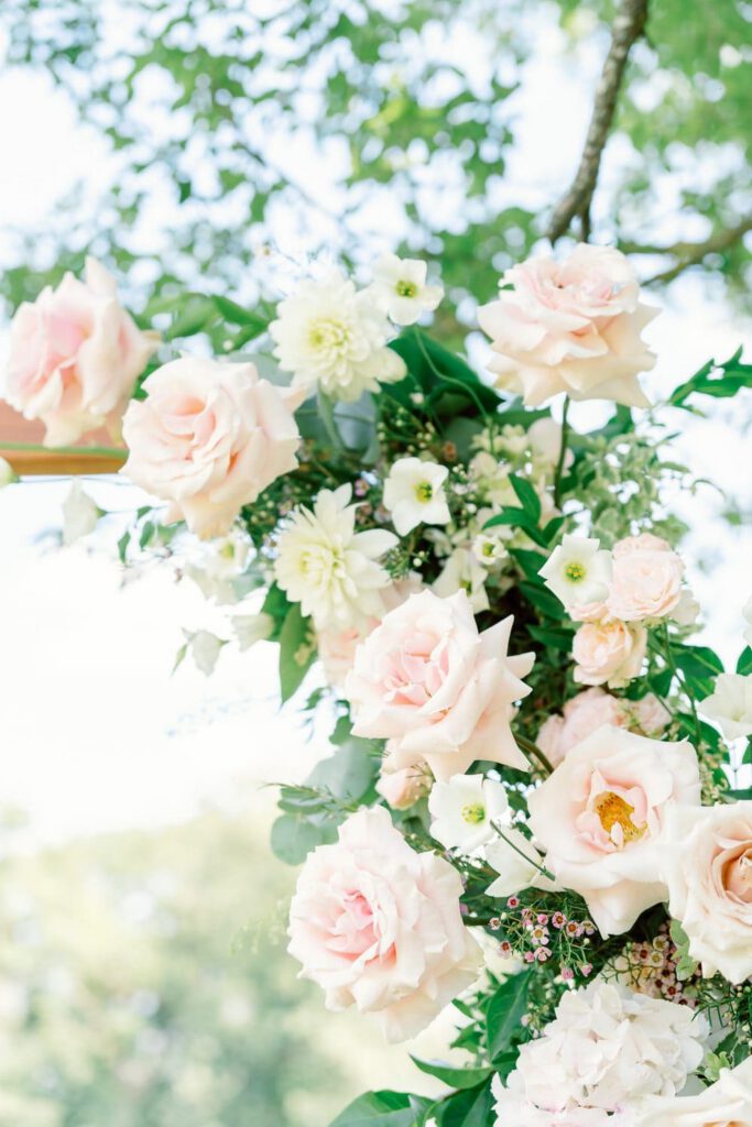 pastel flowers on the ceremony arch