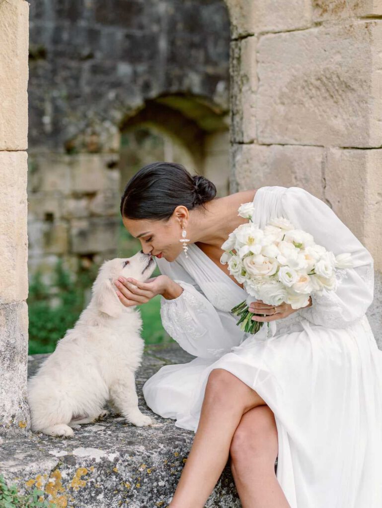 Bride portrait in an old abbey with a white dog