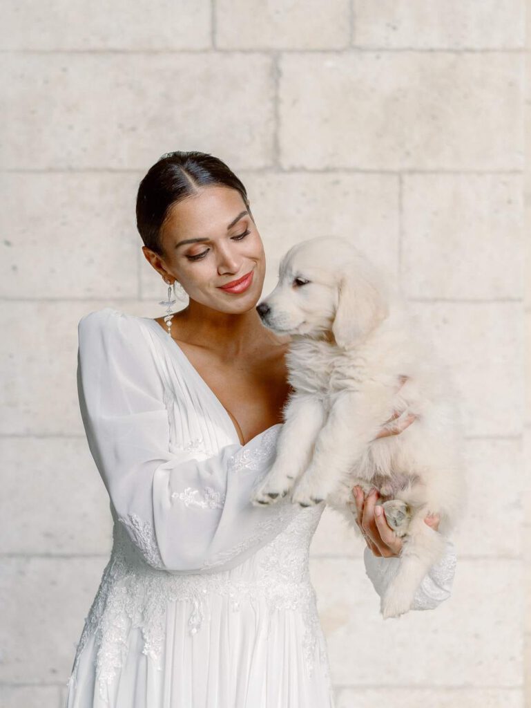 Bride portrait in an old abbey with a white dog