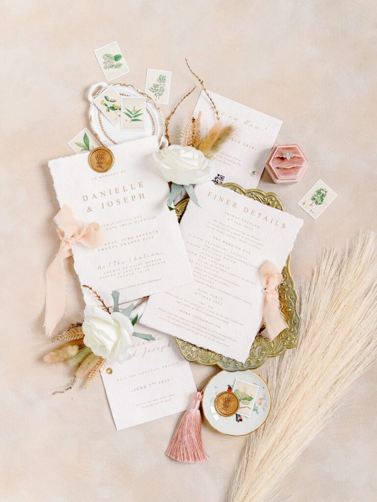 wedding invitation flatlay in beige, blush and pink colors