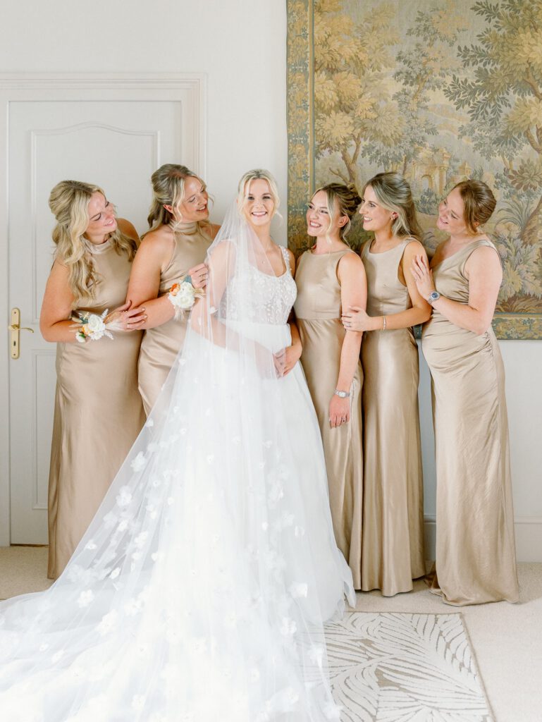 Bride and her bridesmaids with champagne dresses